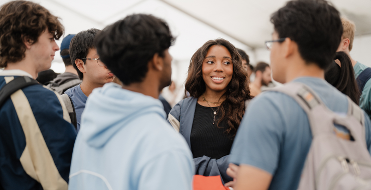 Students speaking with each other at event