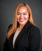 Photo of woman with auburn hair in black suit