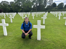 UNG Student Kyle Gallentine Kneeling Next to Cross