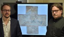 Georgia Tech professor David Citrin (right) and adjunct professor Alexandre Locquet stand in front of an image of the 16th-century&nbsp;funerary&nbsp;cross used in their study. Credit: Nicolas Jacquet